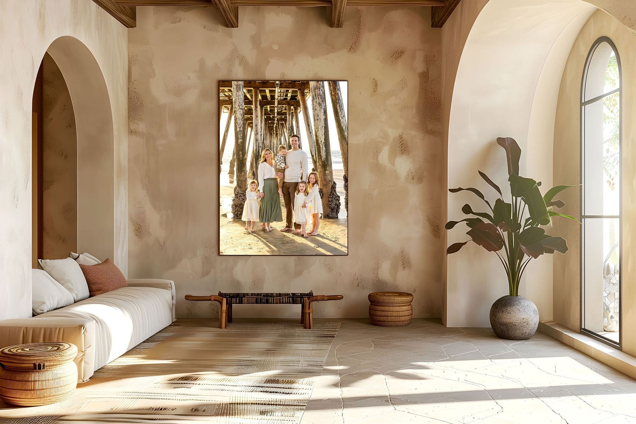 A large fine art family portrait hangs on a wall in a living room